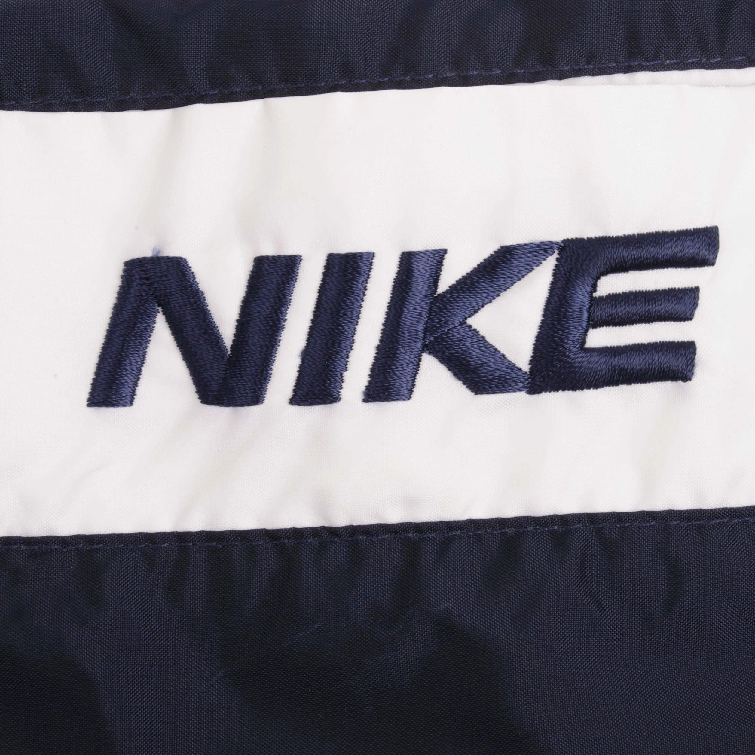 VINTAGE NIKE WHITE AND BLUE NYLON TRACK PANTS 1990S SIZE LARGE