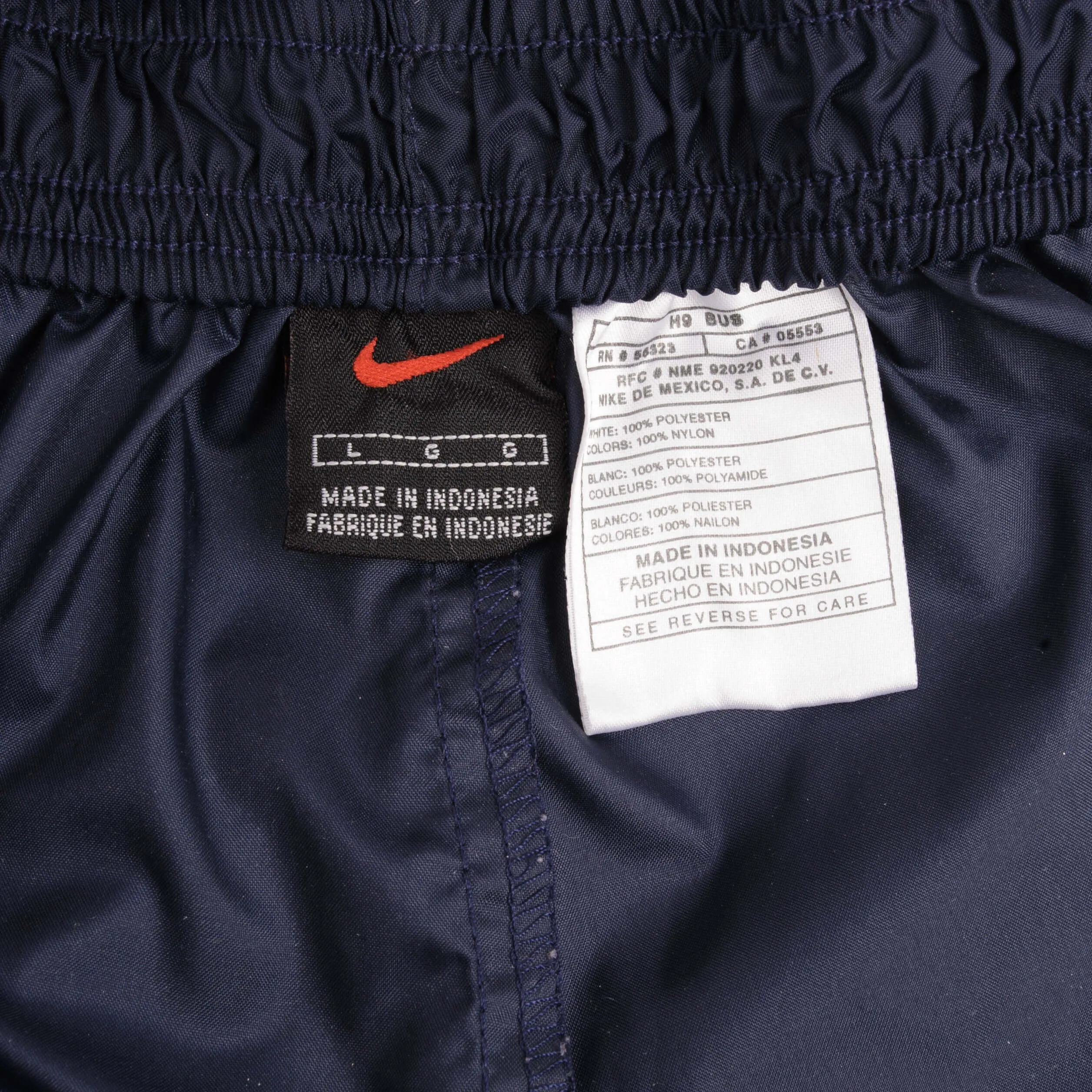 VINTAGE NIKE WHITE AND BLUE NYLON TRACK PANTS 1990S SIZE LARGE
